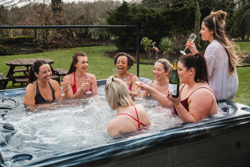 girl friends celebrating in a hot tub
