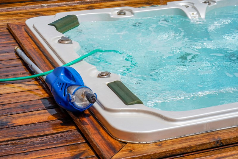 hot tub with hose and cleaner
