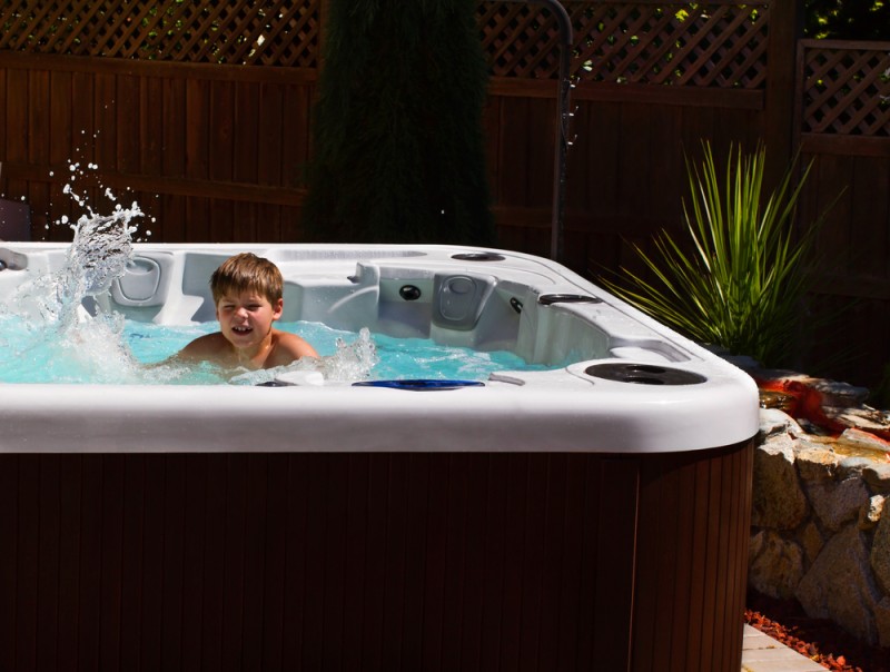 kid playing in a hot tub